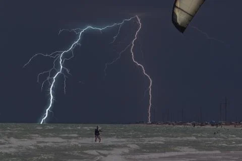 Lightning at sea beach on A thunderstorm cloud Stock Photos