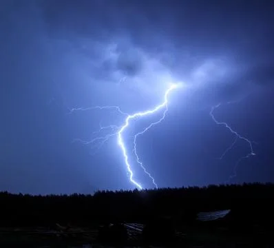 lightning in sky on the background of trees
