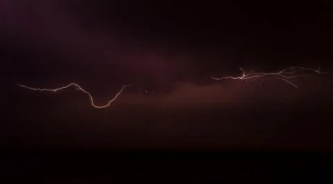 Lightning on the sky over the ocean Stock Photos