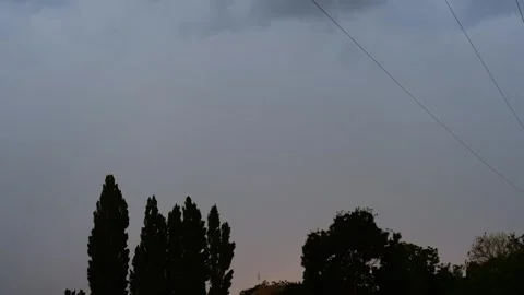 Lightning, slow motion. A cloudy sky with a few trees Stock Footage 274064952