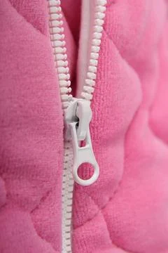Lightning on soft pink clothes with a white lock. Close-up. Detail of clothing.  Stock Photos