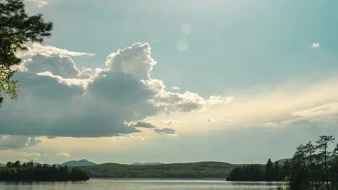 Lightning storm clouds forming and changing over lake 4k 24p 24fps Stock Footage 194716776