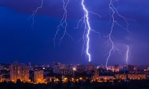 Lightning storm over city Stock Photos