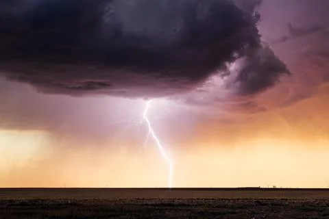 Lightning storm at sunset Stock Photos