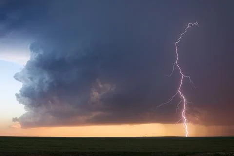 Lightning strike and storm clouds Stock Photos
