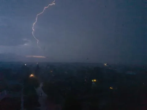 A lightning strike on the cloudy sky Stock Photos
