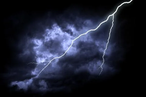 Lightning strike on the dark cloudy sky. Stock Photos