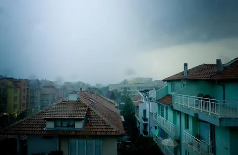 Lightning strike over dark blue sky in night city Stock Photos