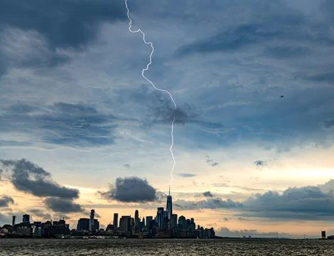 Lightning strike over Lower Manhattan in Daytime storm Stock Photos