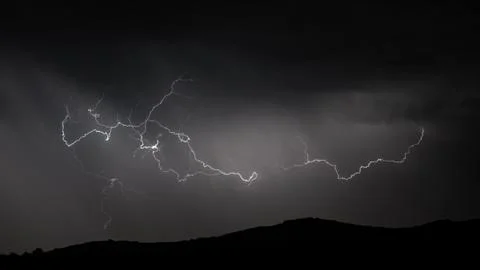 Lightning strike over mountain range, panorama Stock Photos