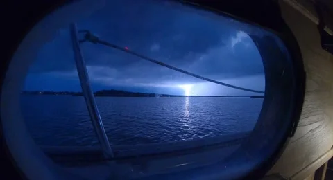 Lightning Strike seen through Sailboat Porthole Stock Footage 222936652