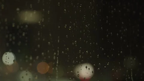 Lightning strikes in the background during a thunderstorm as rain falls in s Stock Footage 241498123