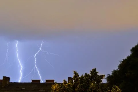 Lightning strikes behind building during storm in Croatia Stock Photos