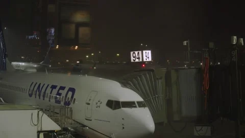 Lightning strikes behind gate 94 at Newark during a thunderstorm with rain f Stock Footage 241498457