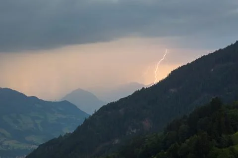 Lightning strikes between the mountains Stock Photos