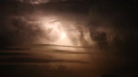 Lightning strikes during a thunderstorm in the night sky with storm clouds Stock Footage 55884464