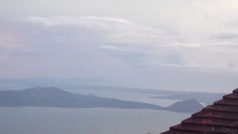 Lightning strikes multiple times in the distance overlooking taal volcano Stock Footage 249448470