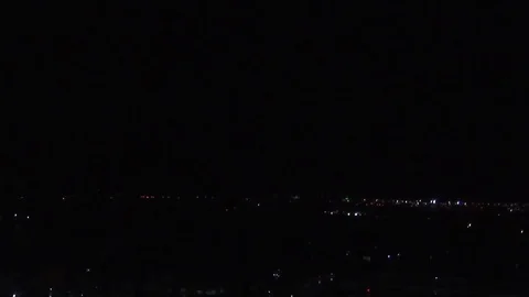 Lightning strikes at night over a distant city. Stock Footage 74796889