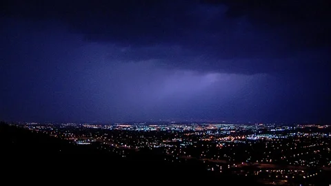 Lightning strikes at night over downtown Salt Lake City, Utah. Stock Footage 99404800