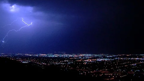 Lightning strikes at night over downtown Salt Lake City, Utah. Video stock 99404899
