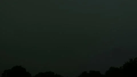 Lightning strikes over trees at night. Timelapse of thunderstorm weather Stock Footage 235639171