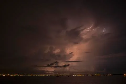 Lightning strikes through the cloud into the chimney of the factory, Singapor Stock-Fotos