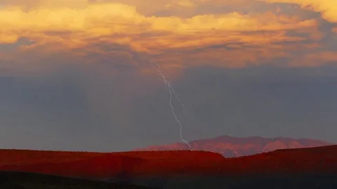 Lightning Strikes Under Sunset Clouds in the Desert Stock Footage