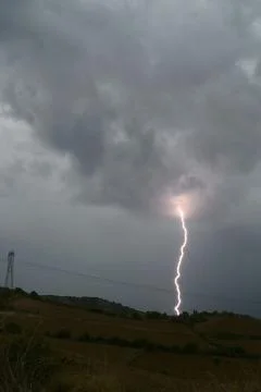 With lightning striking a hill Stock Photos