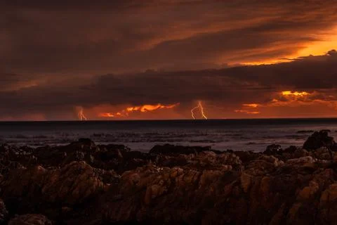 Lightning striking over ocean Stock Photos