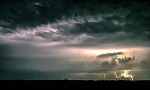 Lightning in the summer, thunder. Evening in the dark Stock Photos