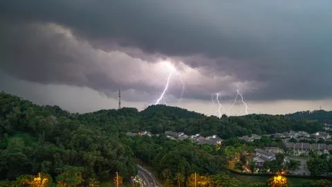Lightning thunder storm and darkest clouds over a hill Stock Photos