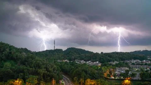 Lightning thunder storm and darkest clouds over a hill Stock Photos