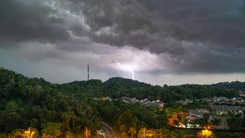 Lightning thunder storm and darkest clouds over a hill Stock Photos