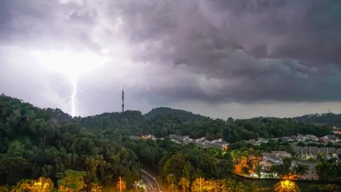 Lightning thunder storm and darkest clouds over a hill Stock Photos