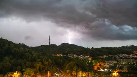 Lightning thunder storm and darkest clouds over a hill Stock Photos