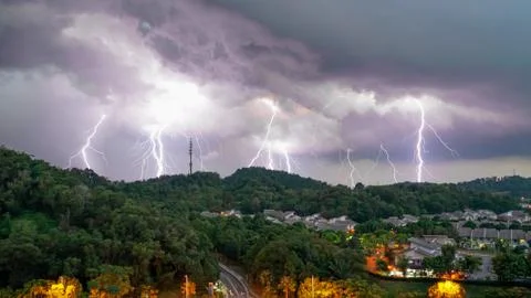 Lightning thunder storm and darkest clouds over a hill Stock Photos