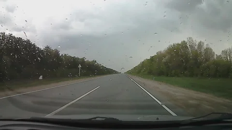 Lightning in a thunderstorm over the road, the view from the car, filmed on acti Stock Footage 89929581