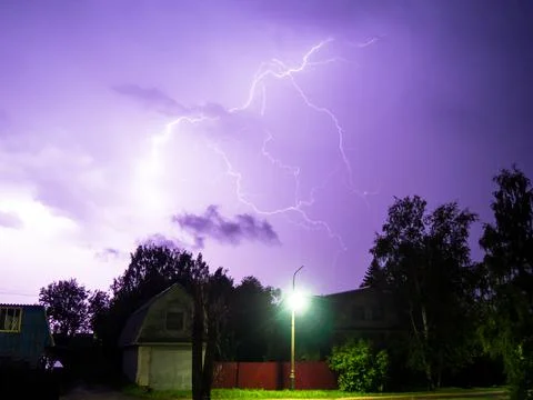 Lightning in a thunderstorm over the town. Lightning in night sky. Lightning  Stock Photos