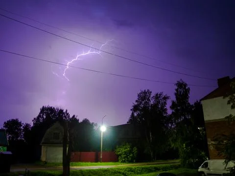 Lightning in a thunderstorm over the town. Lightning in night sky. Lightning  Stock Photos