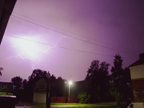 Lightning in a thunderstorm over the town. Lightning in night sky. Lightning  Stock Photos