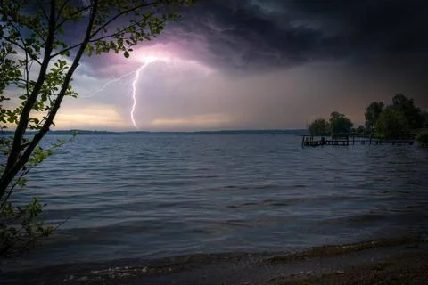 Lightning from a thunderstorm strikes a lake 스톡 사진