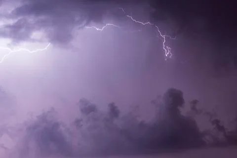 Lightnings in the clouds on the horizon Stock Photos