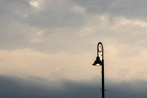 Lightpost against clouds Stock Photos
