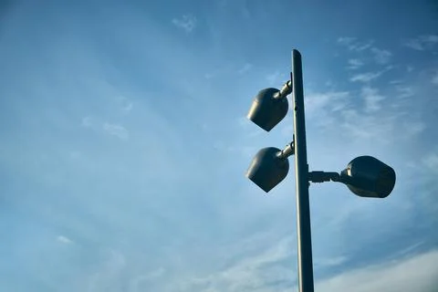 Lightpost with three lanterns opposite sky 写真素材