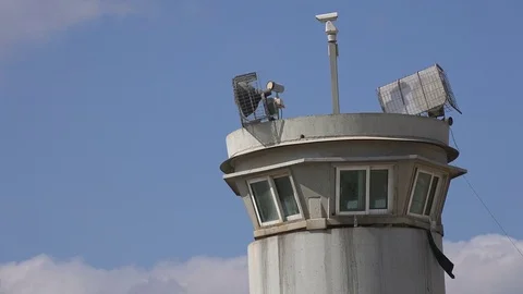 Lights and security cameras on watchtower separation wall West Bank Stock Footage 71486141