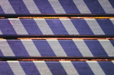 Lights and shadows pattern on a park seat in San Sebastian, Spain Stock Photos