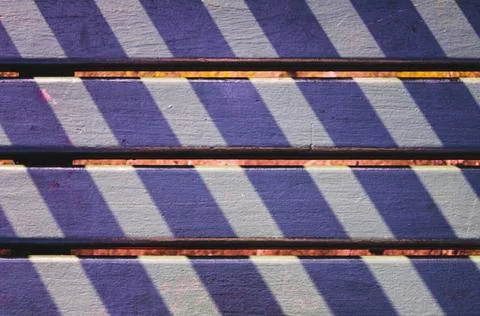  Lights and shadows pattern on a park seat in San Sebastian, Spain Straigh... Stock Photos