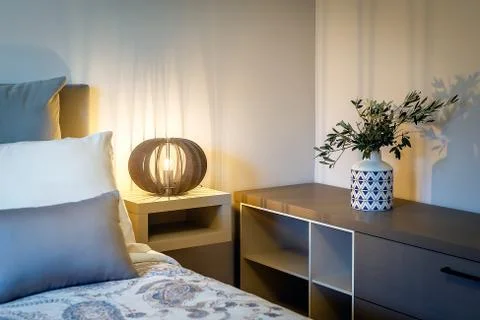 Lights on the bedside table by the bed Stock Photos