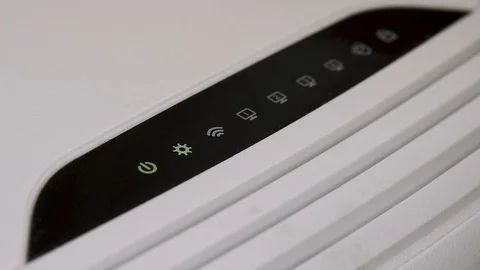 Lights blink on a internet router box in an office Stock Footage 124440548