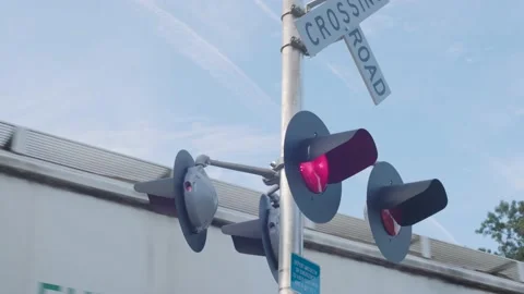 Lights Blinking at a Railroad Crossing as Train Passes Stock Footage 203805661